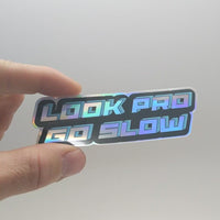 Video of "Look pro / go slow" sticker showing iridescent chrome lettering 