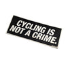 "Cycling is not a crime." sticker in white block letters and black background